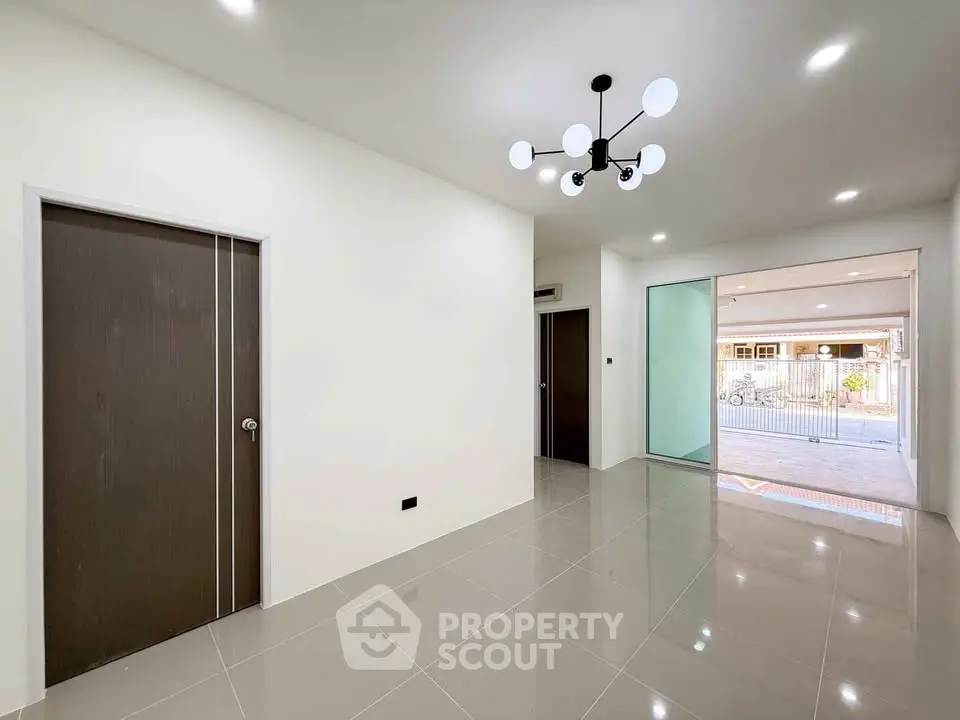 Modern minimalist interior with sleek lighting and glossy tiled floors, showcasing a spacious open layout.