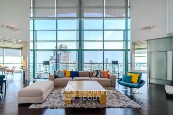 Luxurious living room with floor-to-ceiling windows and stunning city view.