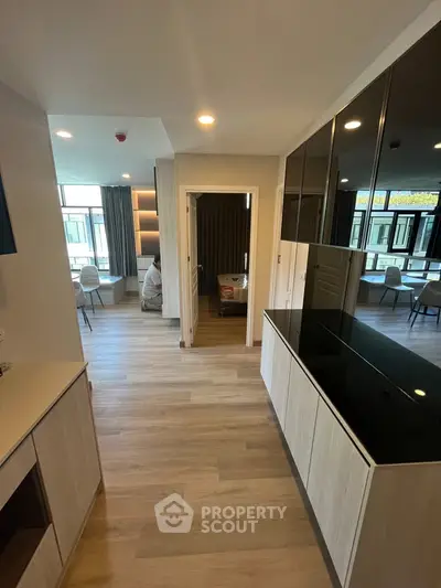 Spacious modern apartment interior with open layout and stylish furnishings.