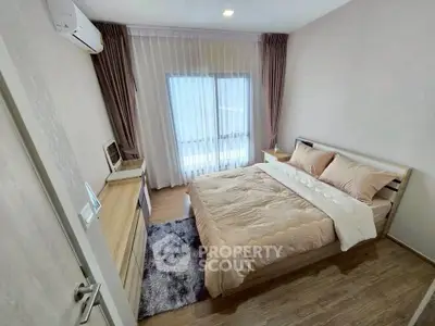 Cozy bedroom with modern decor and natural light, featuring a comfortable bed and stylish furniture.