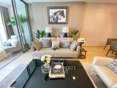 Luxurious living room with elegant decor and floor-to-ceiling windows, featuring a stylish sofa and modern art.
