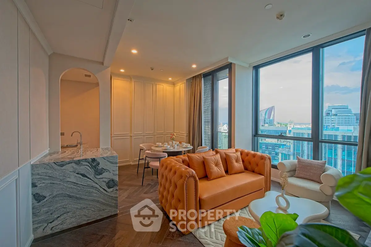 Luxurious living room with stunning city view, elegant furniture, and modern open kitchen layout.