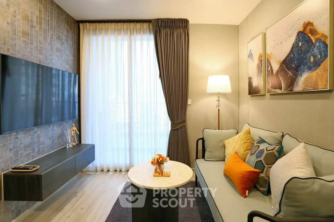 Modern living room with stylish decor and large wall-mounted TV
