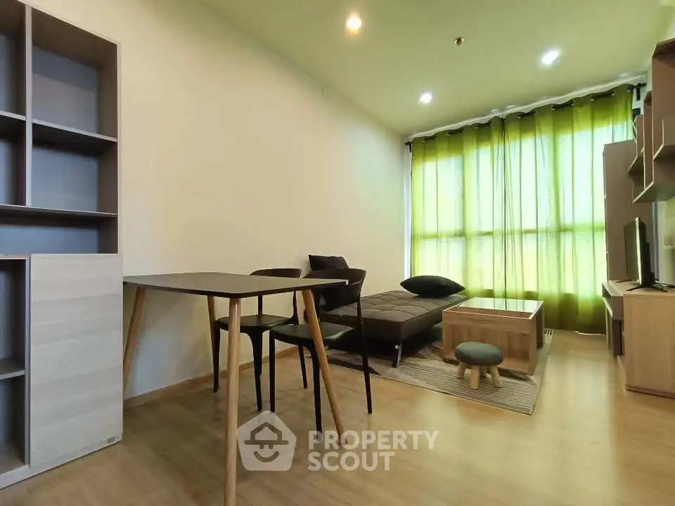 Modern living room with stylish furniture and large window with green curtains