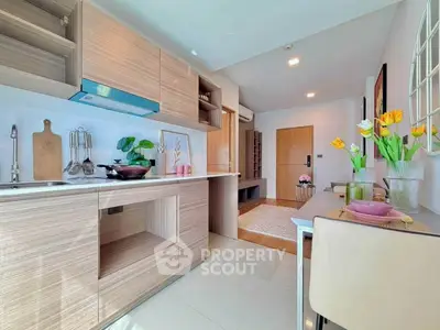 Modern kitchen with open layout and stylish dining area, featuring sleek cabinetry and elegant decor.