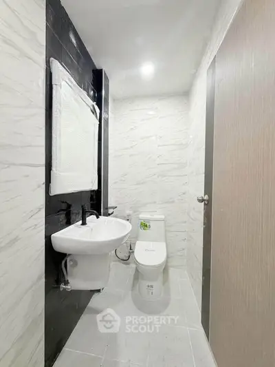 Modern bathroom with sleek design and elegant fixtures in a contemporary apartment.