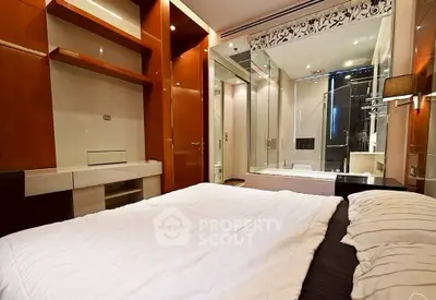 Luxurious bedroom with modern ensuite bathroom and elegant wooden accents.