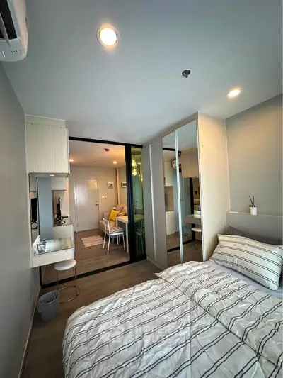 Modern bedroom with stylish decor and mirrored wardrobe in a cozy apartment