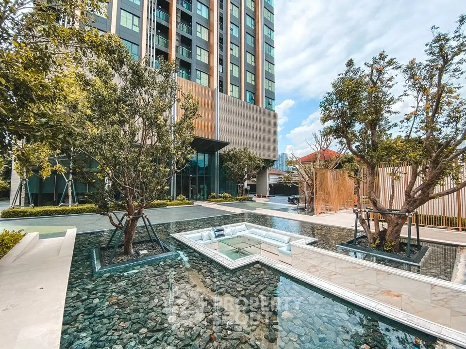 Modern building exterior with landscaped garden and water feature
