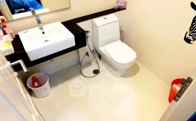 Modern bathroom with sleek fixtures and zebra wall art, offering a clean and stylish design.