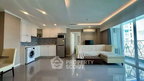 Spacious modern living room with open kitchen and balcony view