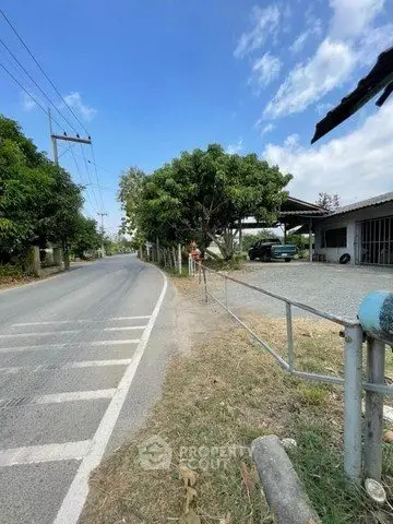 Charming rural property with spacious driveway and lush greenery, perfect for serene living.