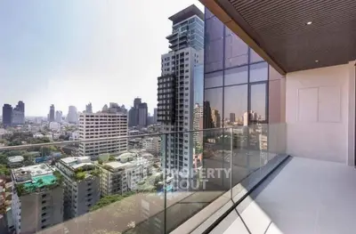 Stunning cityscape view from modern high-rise balcony with glass railing.