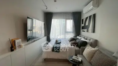 Modern bedroom with stylish decor and natural light, featuring a cozy bed and sleek furniture.