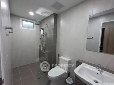 Modern bathroom with sleek shower and elegant fixtures in a contemporary home.