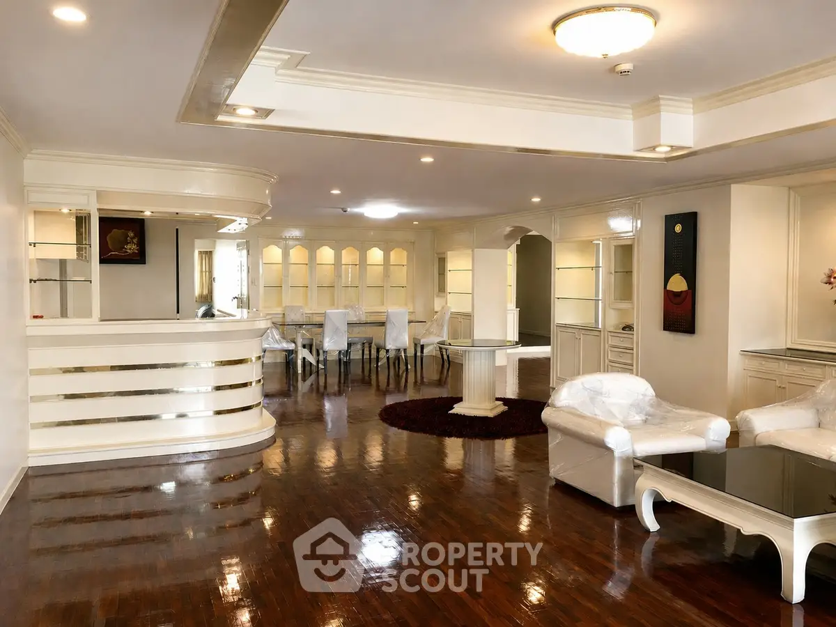 Luxurious living room with elegant decor and polished wooden floors in a spacious open layout.