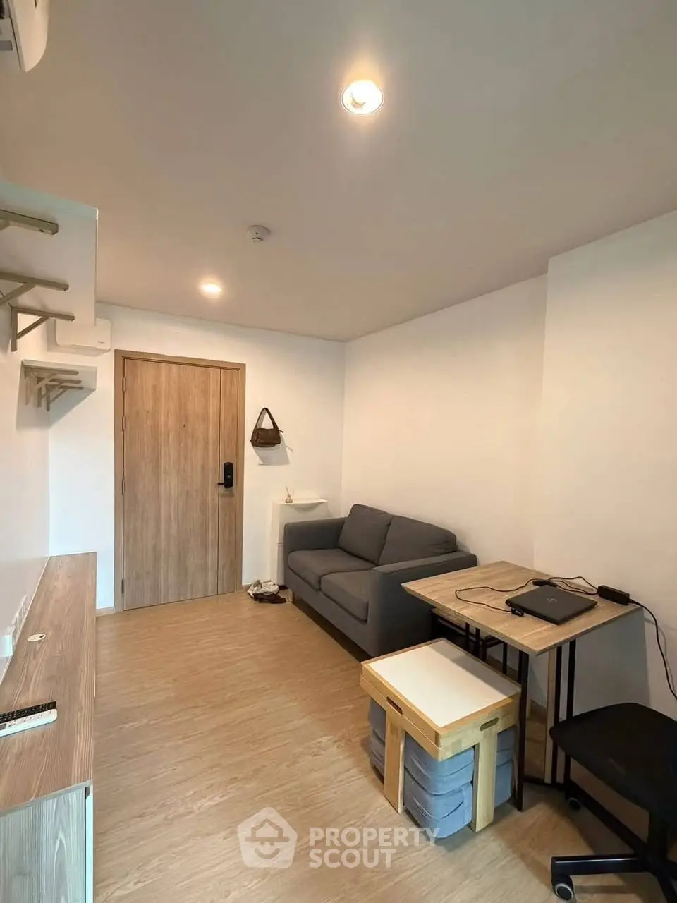 Cozy modern living room with wooden flooring and minimalist furniture