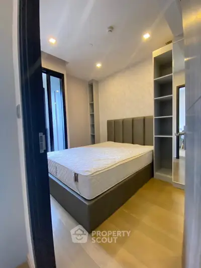 Modern bedroom with sleek design and ample storage in a stylish apartment.