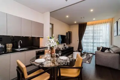 Modern open-plan kitchen and living room with stylish decor and natural light.