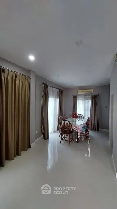 Spacious dining area with elegant curtains and natural light