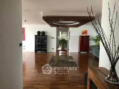 Spacious living room with elegant wooden flooring and stylish decor