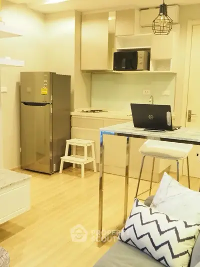 Modern kitchen with open layout and sleek appliances in cozy apartment