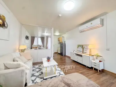 Modern living room with cozy decor and air conditioning in a stylish apartment.