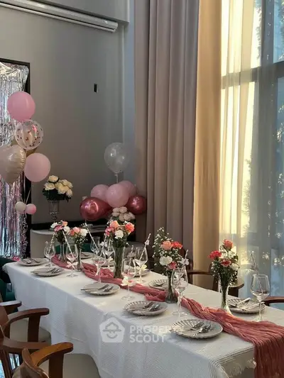Elegant dining room setup with natural light and festive decorations, perfect for hosting gatherings.