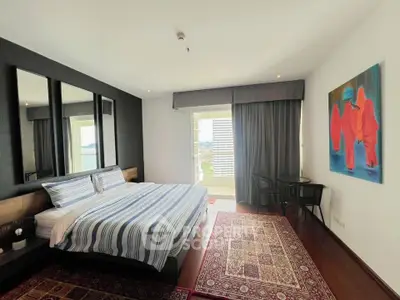 Spacious bedroom with modern decor and large windows offering natural light and city view.