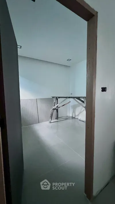 Unfinished room with construction materials and tiled floor