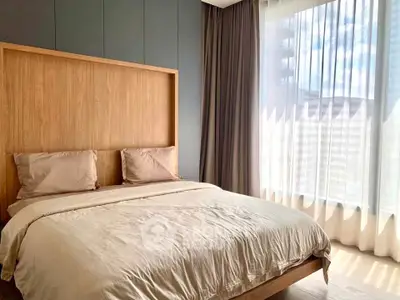 Modern bedroom with large window and elegant wooden headboard