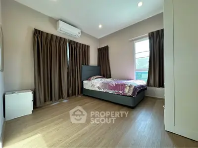 Spacious bedroom with modern decor and natural light