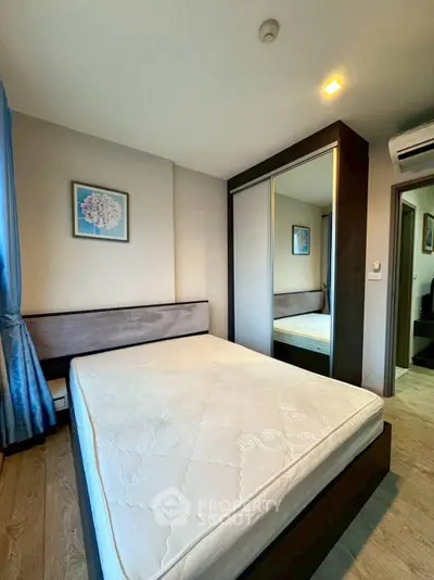 Modern bedroom with mirrored wardrobe and stylish decor