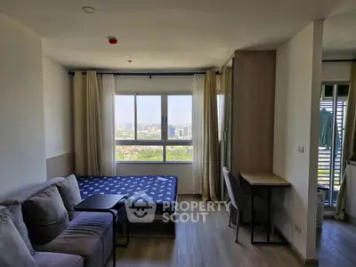 Modern studio apartment with city view, cozy living area, and workspace.