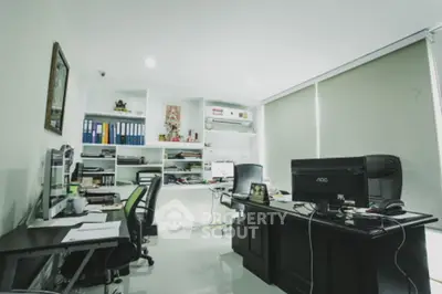 Modern home office with sleek desks and organized shelves, perfect for productivity.