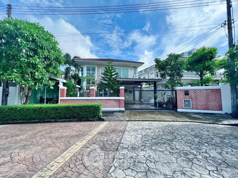 Stunning two-story house with lush garden and spacious driveway in a serene neighborhood.
