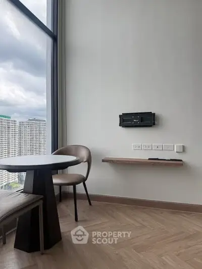 Modern high-rise apartment with large windows and sleek interior design, offering stunning city views.