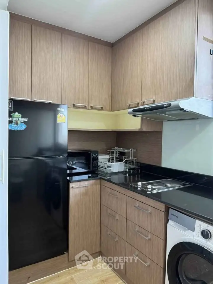 Modern kitchen with sleek appliances and ample storage in a compact layout.