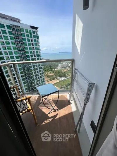 Charming balcony with ocean view in modern high-rise apartment
