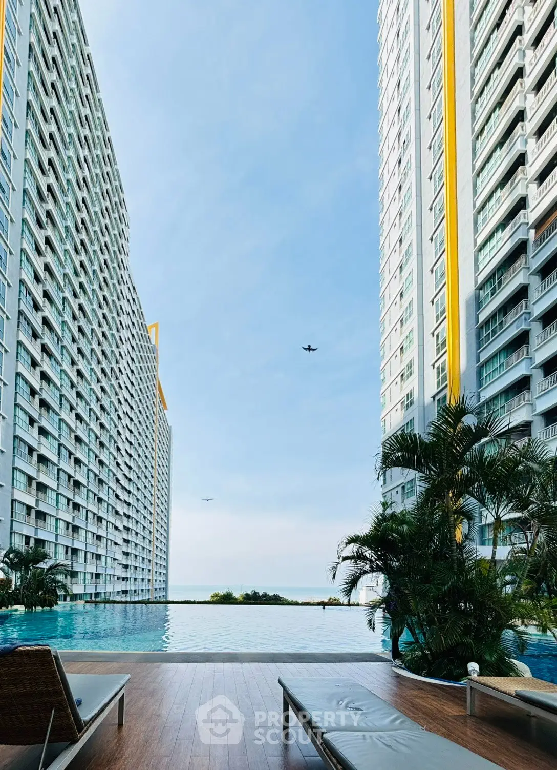 Luxurious high-rise apartment with stunning poolside view and modern amenities.