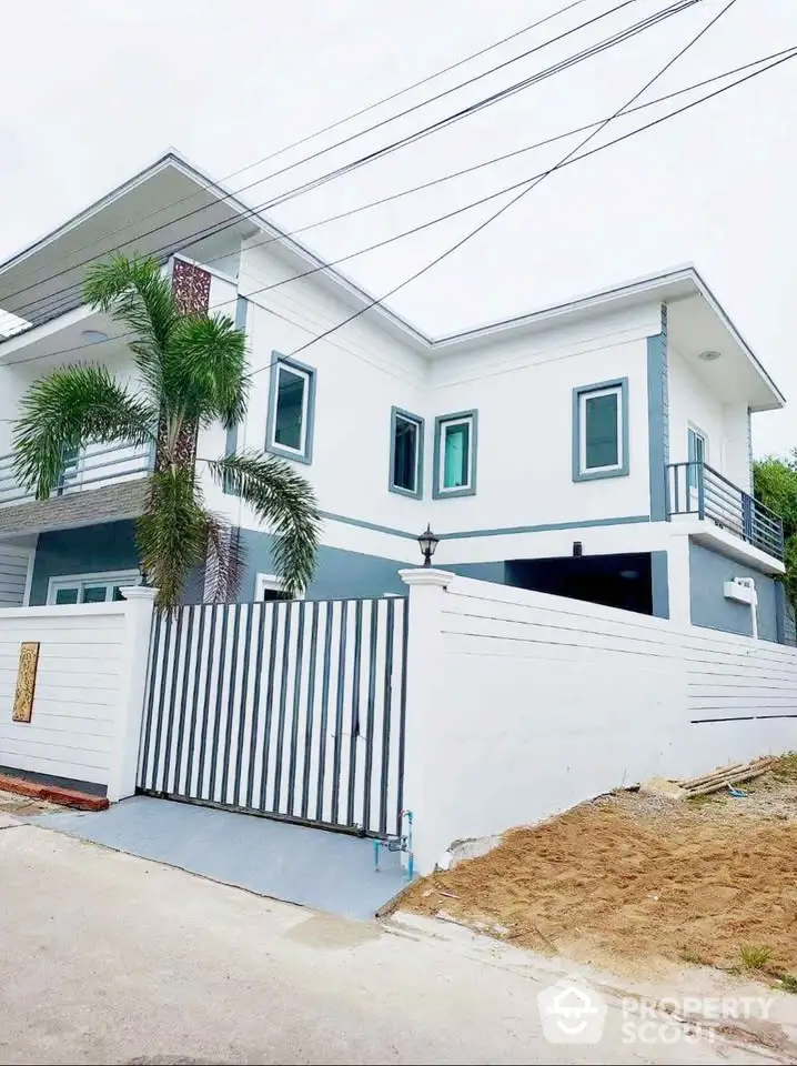 Modern two-story house with sleek design and gated entrance