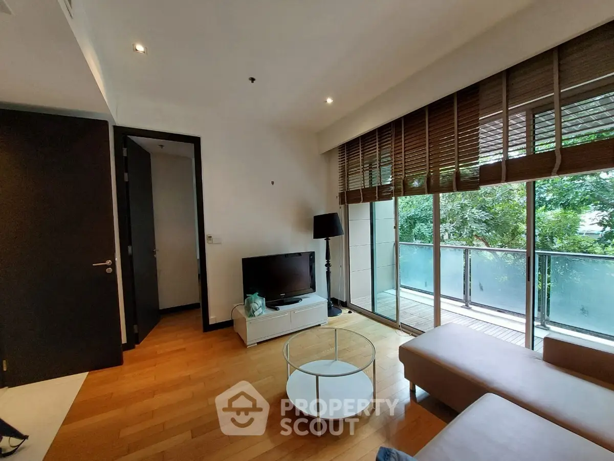 Modern living room with large windows and balcony view