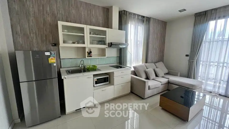 Modern open-layout kitchen and living room with sleek design and natural light