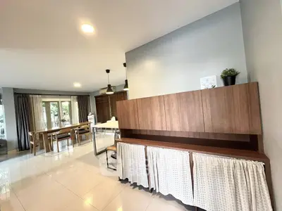 Spacious open-plan living and dining area with modern decor and ample natural light.