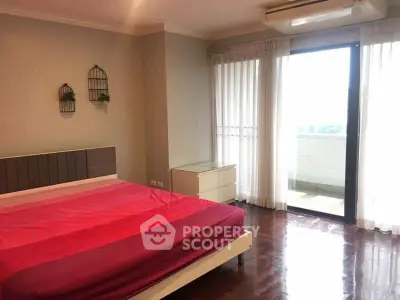 Spacious bedroom with balcony access and natural light