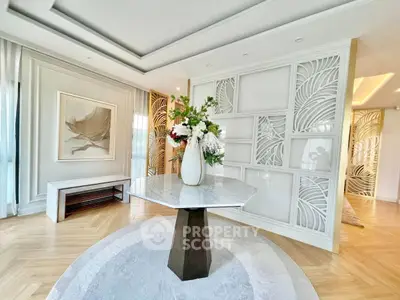 Elegant modern living room with stylish decor and intricate wall design