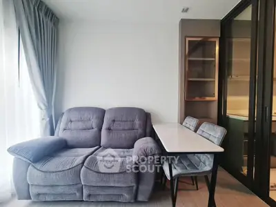 Cozy living room with plush sofa and dining area in modern apartment