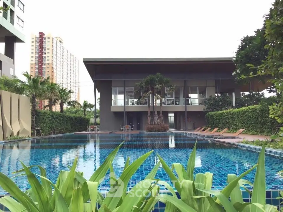 Luxurious residential pool area with modern architecture and lush greenery