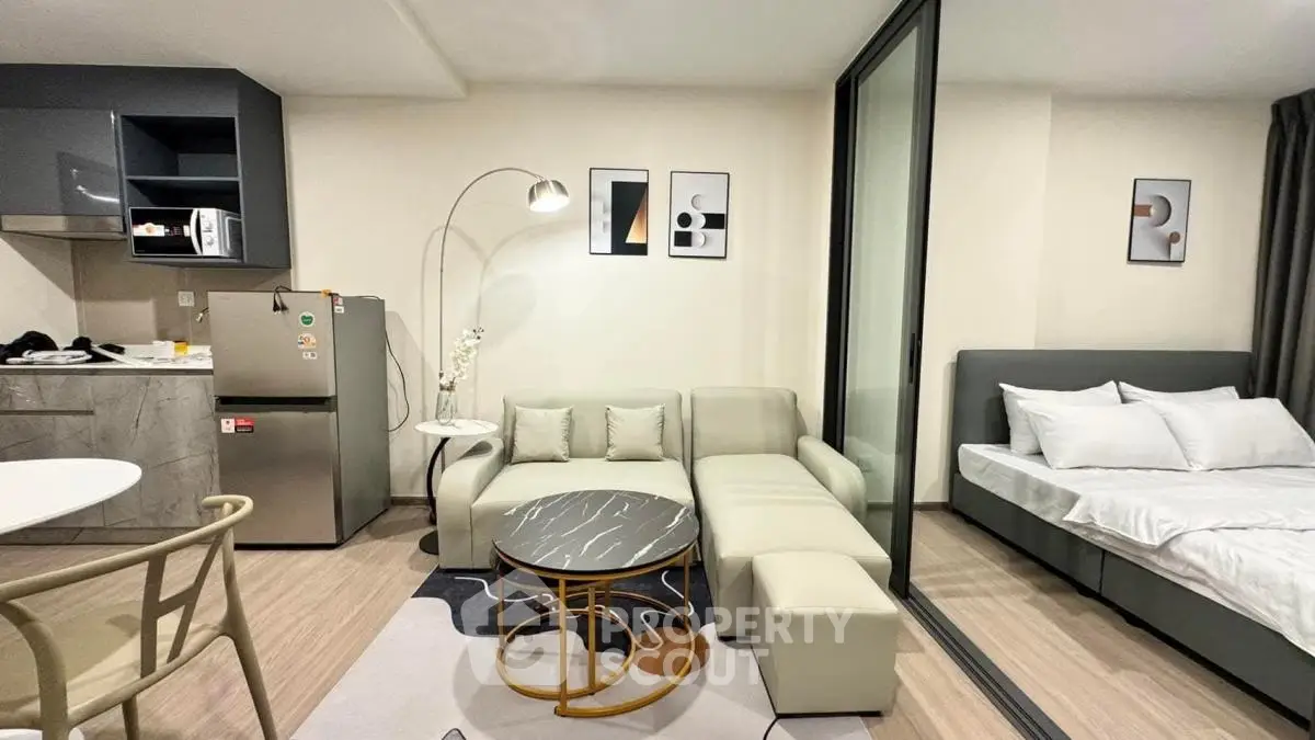 Modern studio apartment with open layout, stylish furniture, and cozy bedroom area.