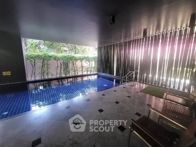 Luxurious indoor pool area with modern design and natural light